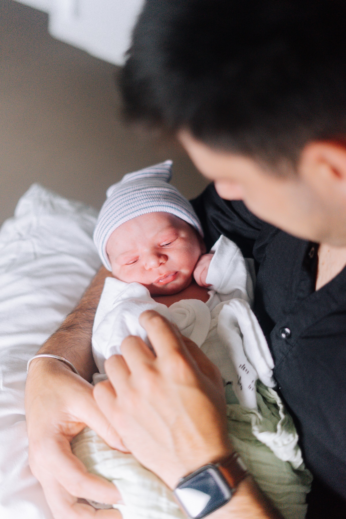 A man holding a newborn baby