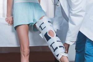 A doctor helping a patient with a leg brace