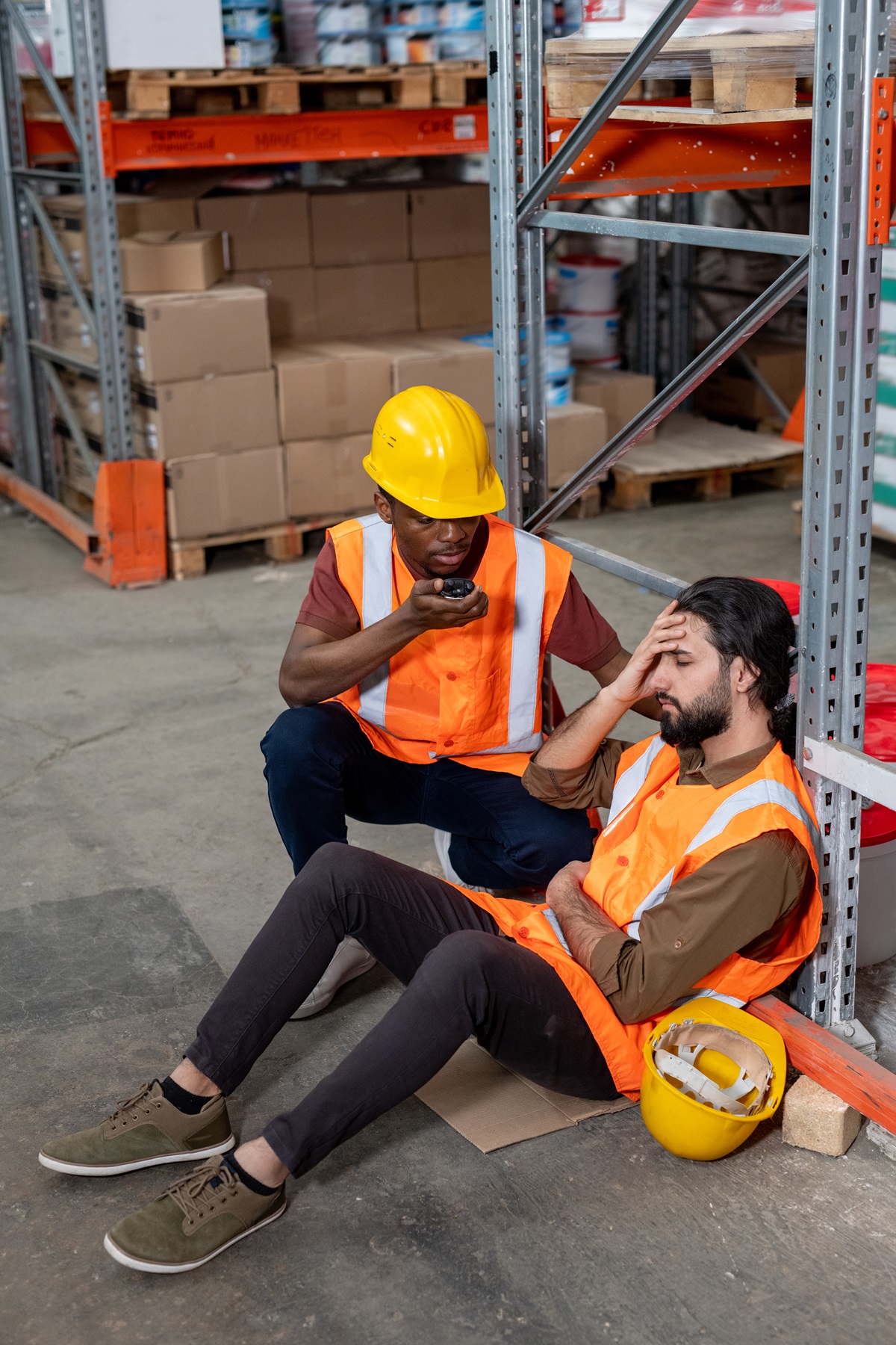 A worker helping another worker injured on the job