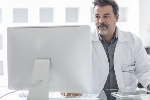 A doctor working on a computer