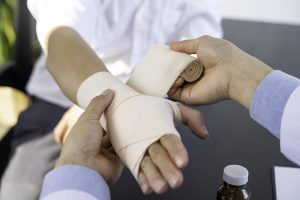 A patient's hand being wrapped