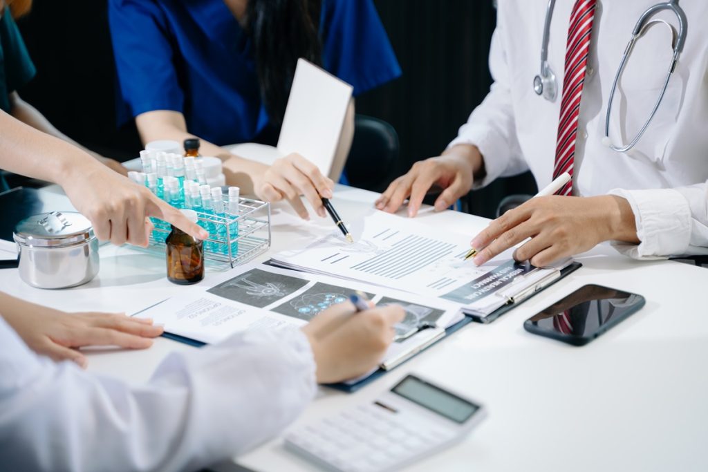 A medical cost assessment team working on a report