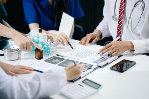 A medical cost assessment team working on a report