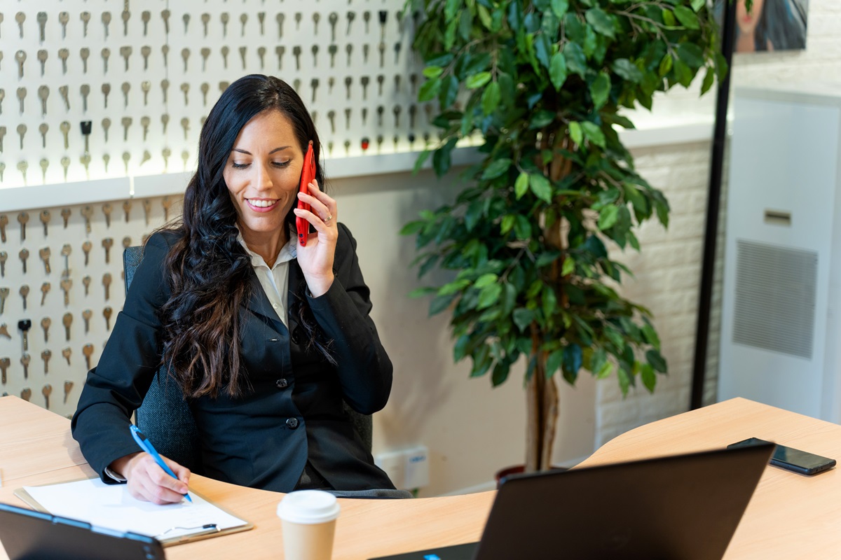 A lawyer taking notes while on the phone