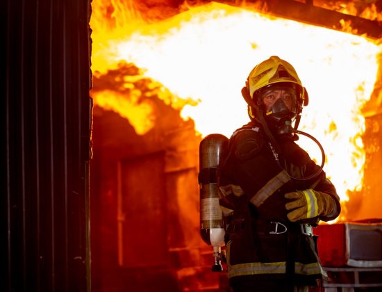 A firefighter in a burning house